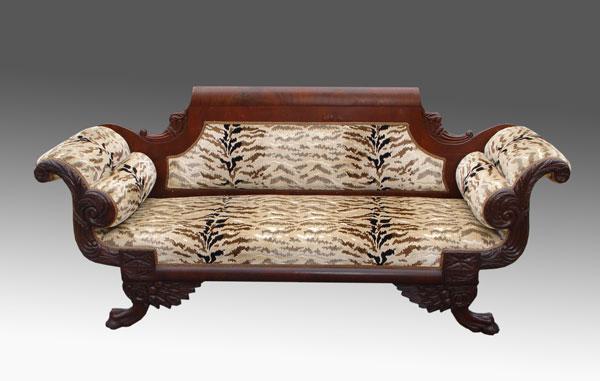 Appraisal: ROLLED ARM EMPIRE SOFA Carved cornucopia mahogany veneer carved framework