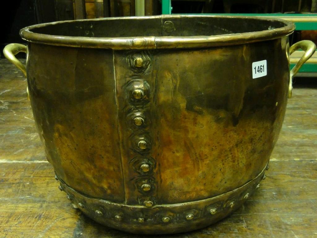 Appraisal: A copper log bin of circular form with riveted detail