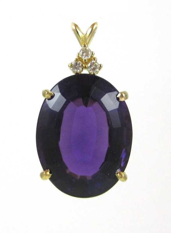 Appraisal: AMETHYST DIAMOND AND FOURTEEN KARAT GOLD PENDANT with three round-cut