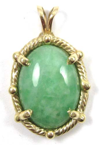 Appraisal: JADE AND FOURTEEN KARAT GOLD PENDANT four yellow gold prongs