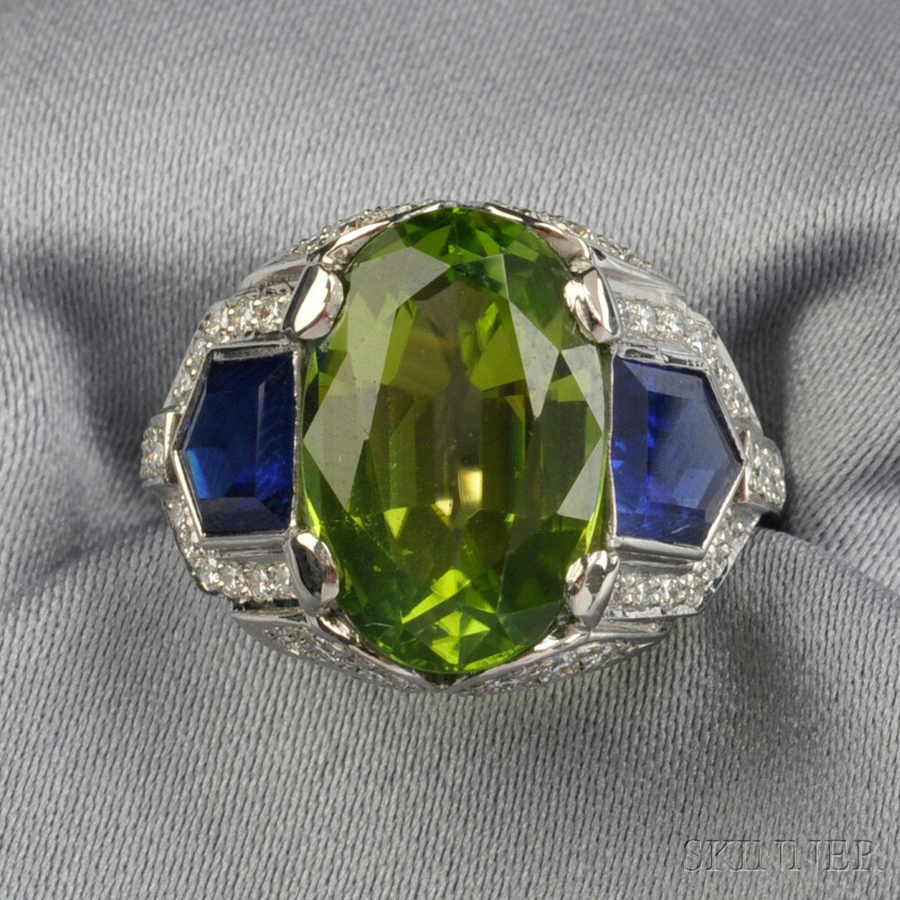 Appraisal: Platinum Peridot and Sapphire Ring prong-set with an oval-cut peridot