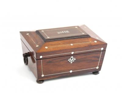 Appraisal: A Regency rosewood and mother-of-pearl inlaid workbox of sarcophagus shape