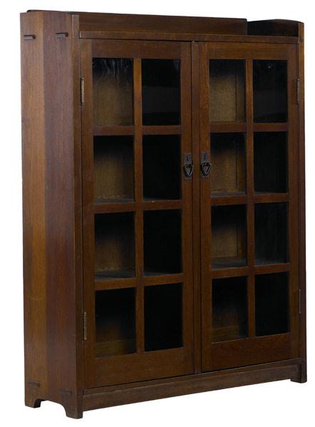 Appraisal: GUSTAV STICKLEY Double-door bookcase with gallery top and three fixed