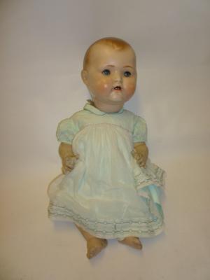 Appraisal: A large German composition baby doll with blue glass sleeping