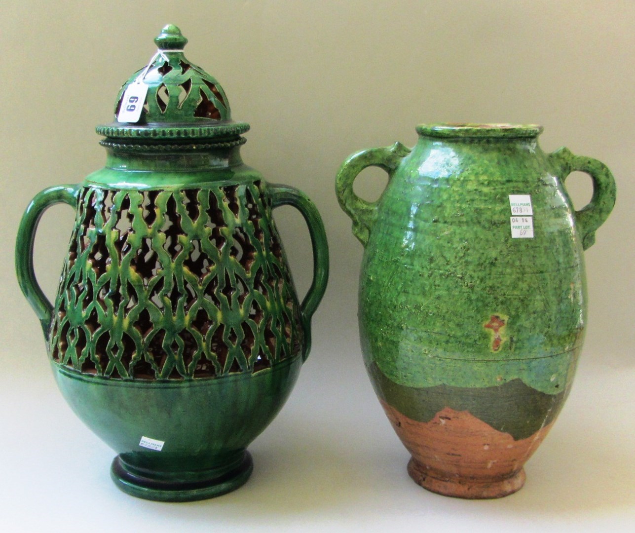 Appraisal: A Continental green glaze earthenware two handled vase with pierced