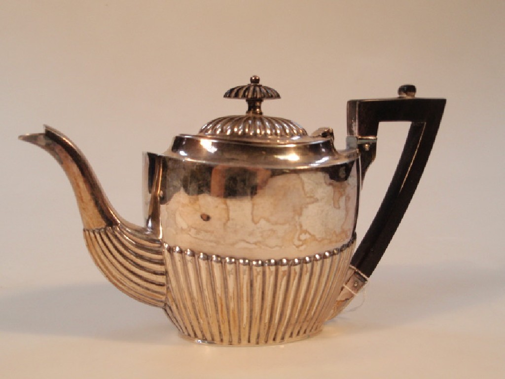 Appraisal: A late Victorian silver bachelor's teapot of semi-fluted oval form