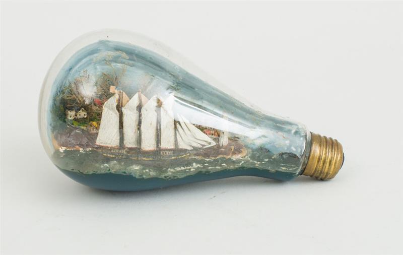 Appraisal: CARVED AND PAINTED SCHOONER MODEL IN A GLASS LIGHT BULB