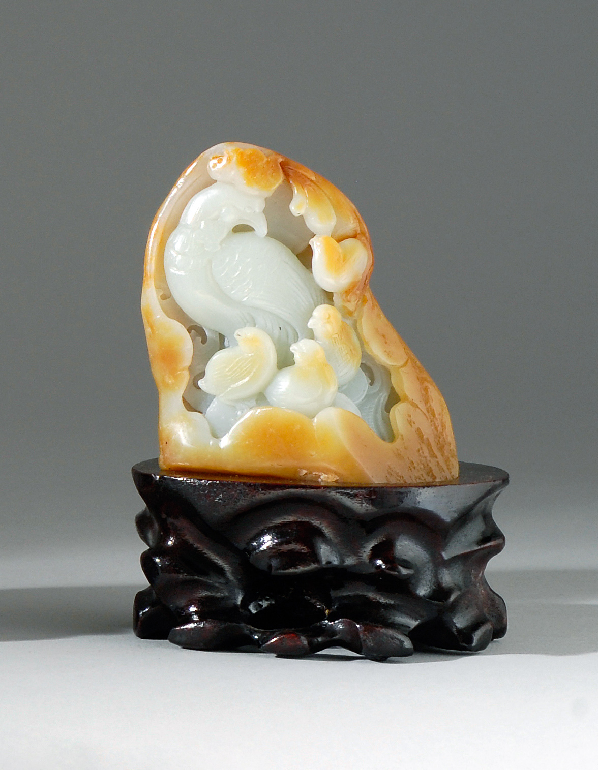 Appraisal: CELADON AND RUSSET JADE CARVING In mountain form with quail