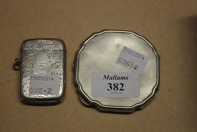 Appraisal: A SILVER COMPACT with engine turned decoration together with a