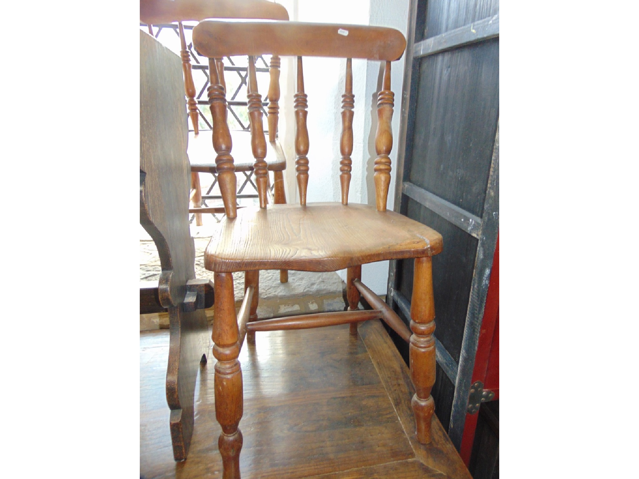 Appraisal: A pair of Windsor elm and beechwood kitchen chairs with