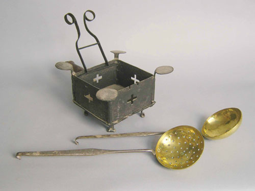 Appraisal: Iron foot warmer together with a strainer and a ladle