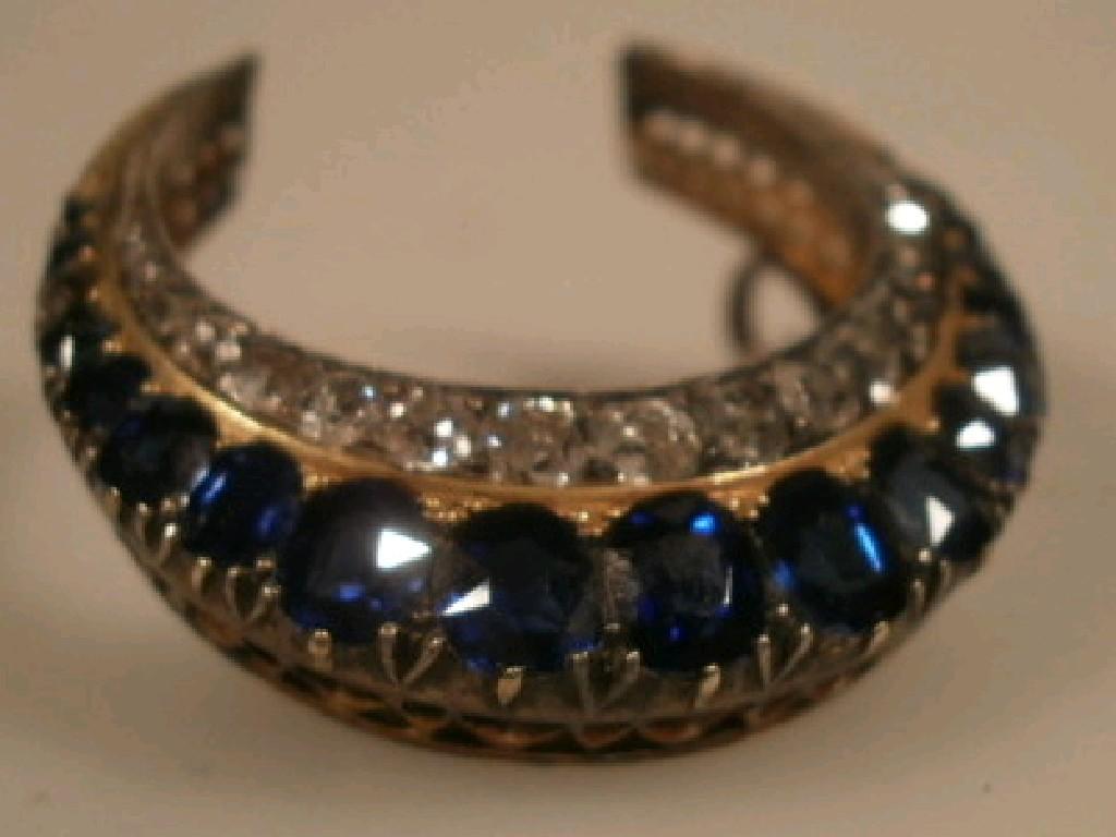 Appraisal: A Victorian crescent brooch set with small diamonds and sapphires