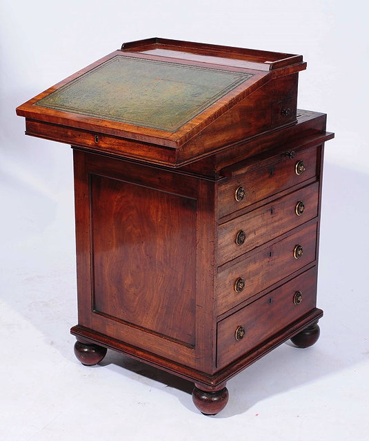 Appraisal: A GEORGE IV MAHOGANY DAVENPORT the sliding top fitted an