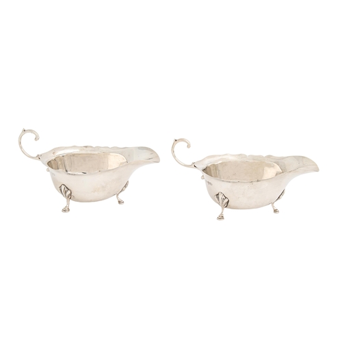 Appraisal: A pair of George VI silver sauceboats with flying scroll