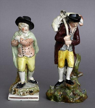 Appraisal: TWO ENGLISH PEARLWARE FIGURES The larger a young shepherd carrying