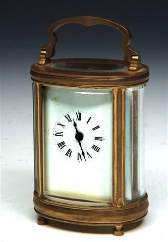 Appraisal: A FRENCH OVAL BRASS CARRIAGE TIMEPIECE with white enamel dial