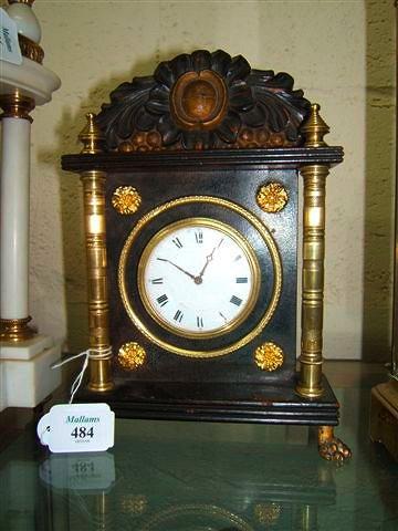 Appraisal: A regency mantel clock with carved surmount turned brass pillars