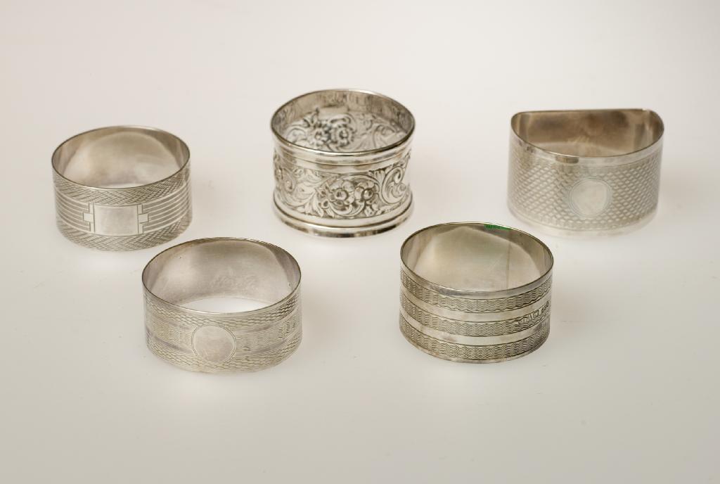 Appraisal: GROUP OF FIVE SILVER NAPKIN RINGS comprising London repousse with