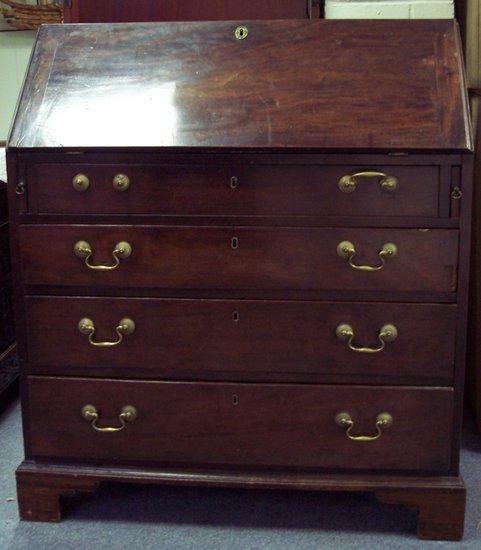 Appraisal: A George III mahogany bureau the fall enclosing a fitted