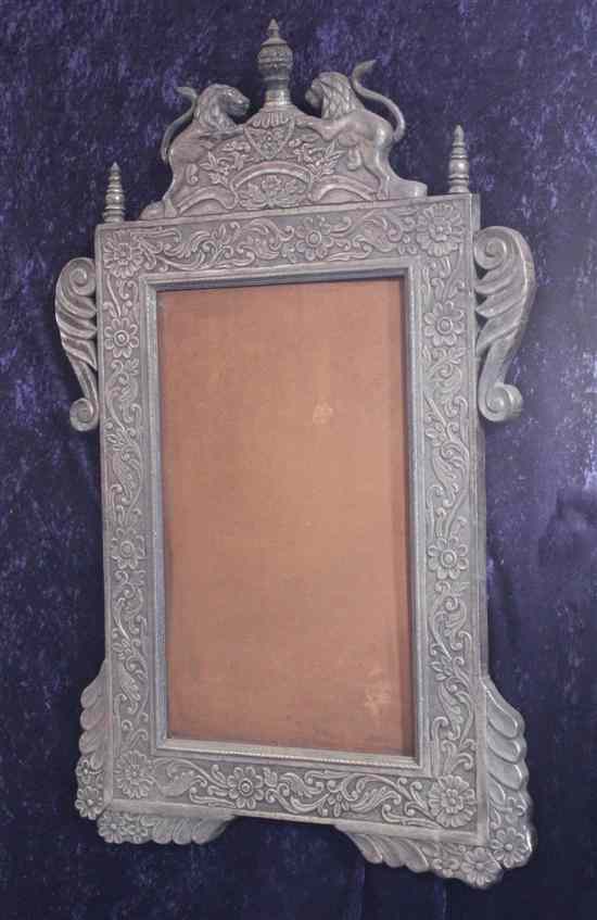 Appraisal: An Indian silver overlaid mirror decorated with lions scrolls and