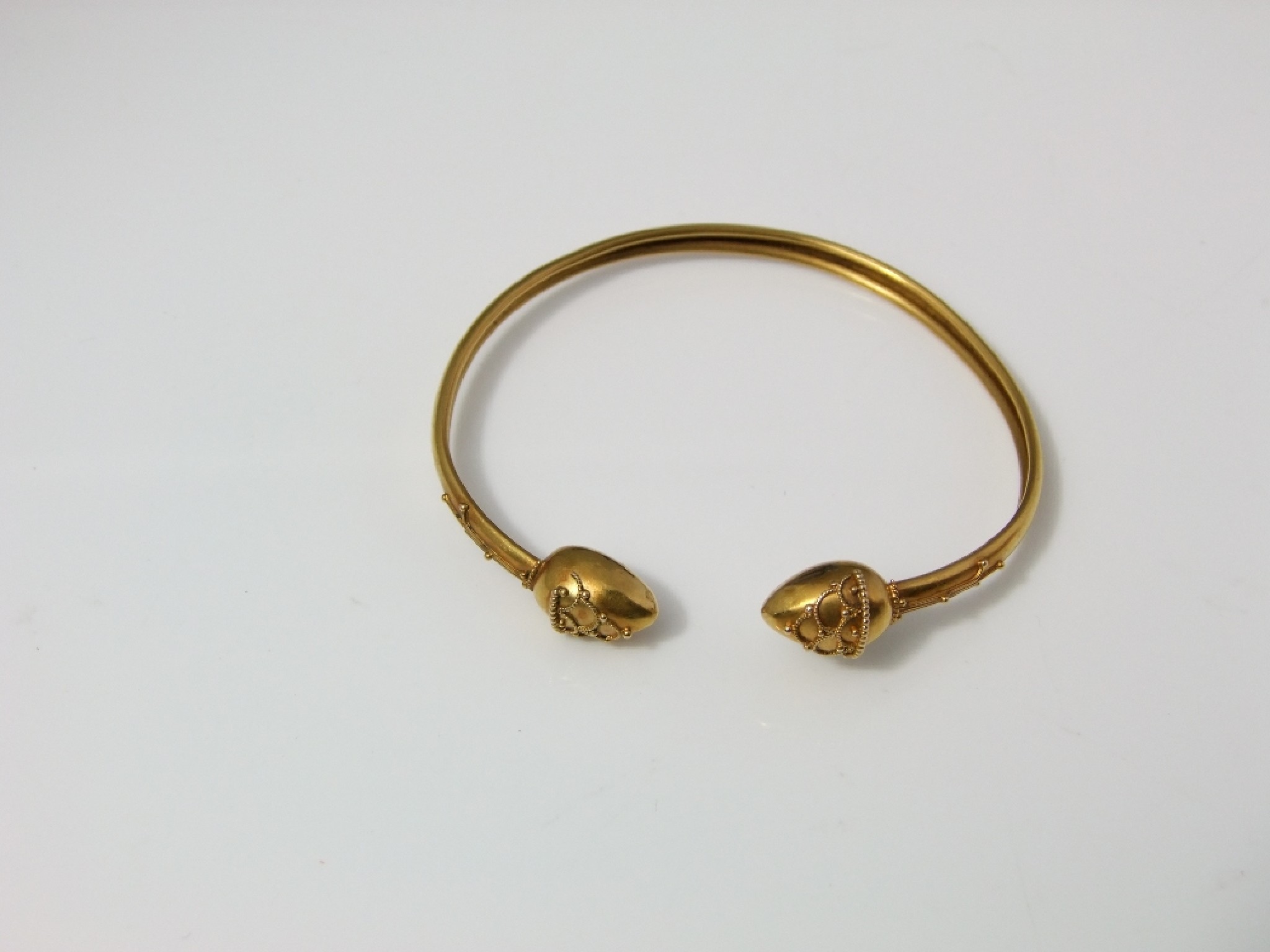 Appraisal: A celtic style ct gold Victorian bangle with applied beaded