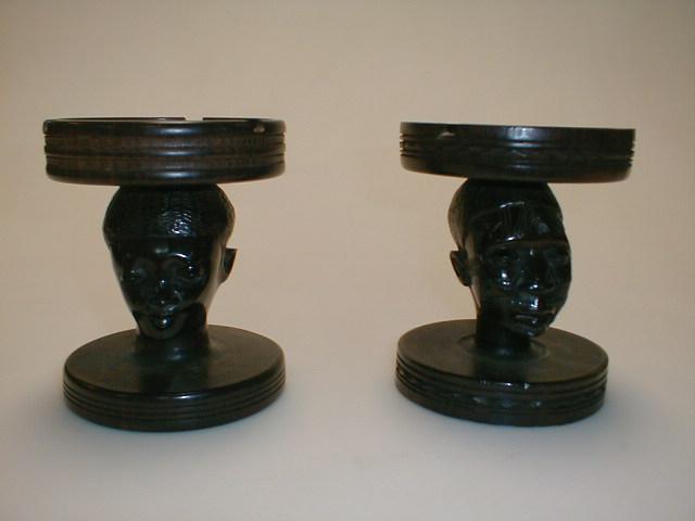 Appraisal: A pair of African hardwood ashtrays each mounted on a