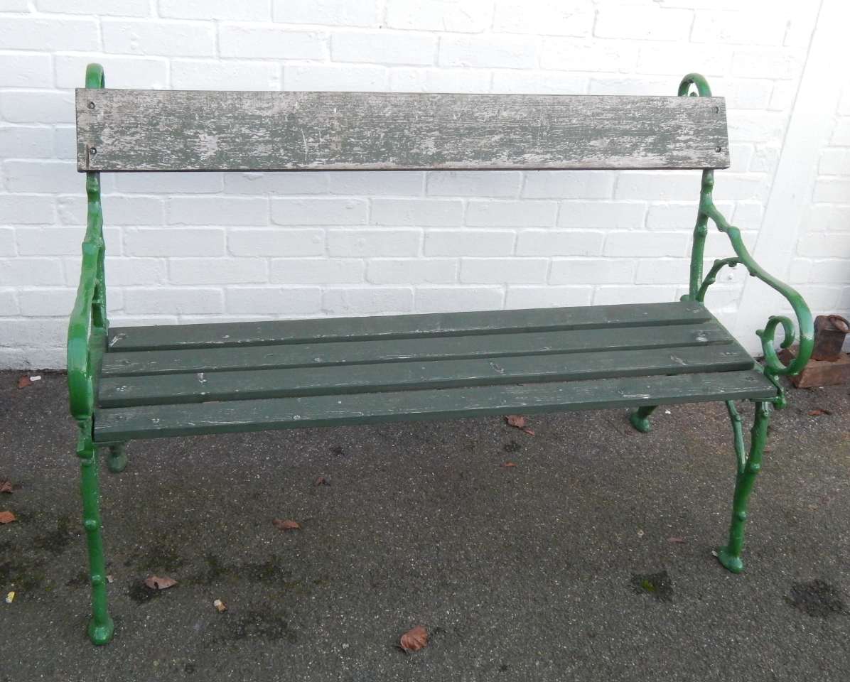 Appraisal: A cast iron and wooden slatted garden bench with scrolling