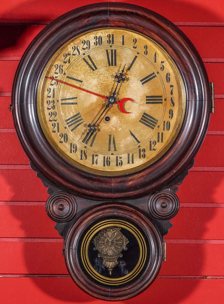 Appraisal: A LOVELL MFG FAUX ROSEWOOD IONIC CALENDAR CLOCK The Meridian