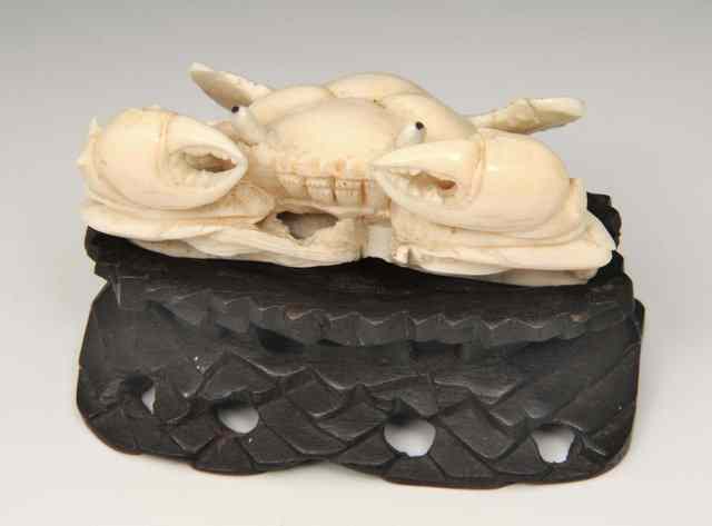 Appraisal: A CARVED IVORY MODEL of a crab on a hardwood