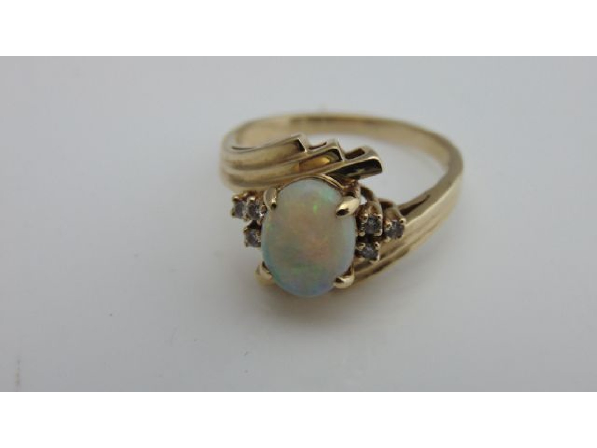 Appraisal: An opal and diamond ring centred with an oval cabochon