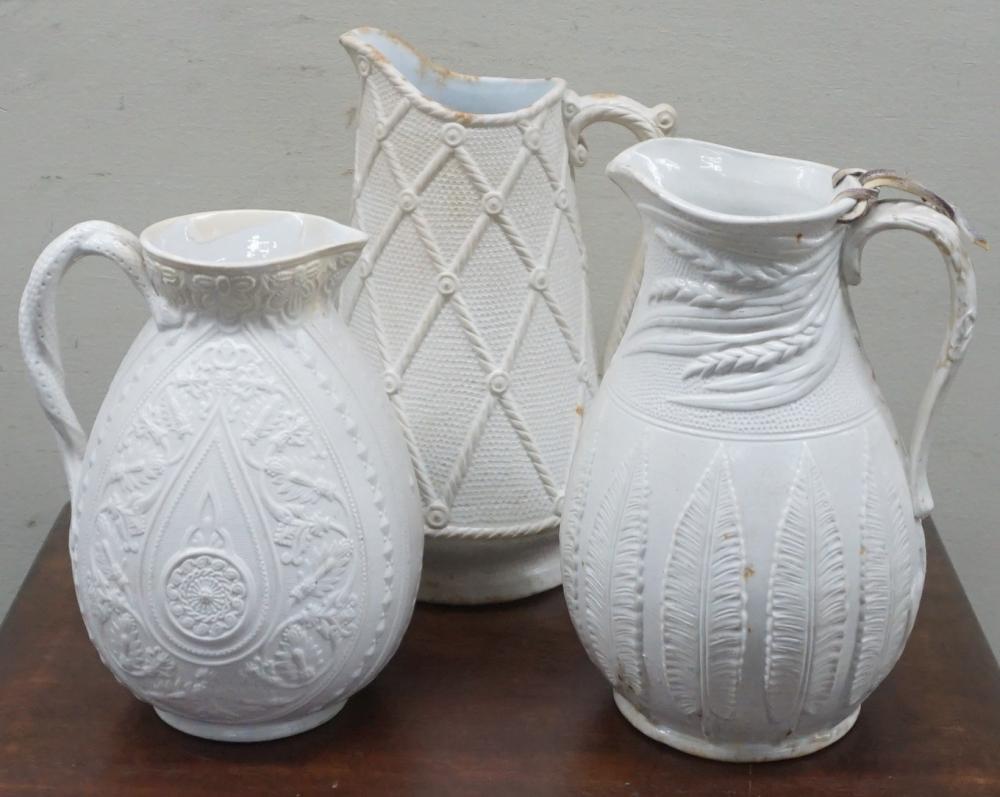 Appraisal: THREE STAFFORDSHIRE WHITE GLAZED STONEWARE PITCHERS CIRCA H OF TALLEST