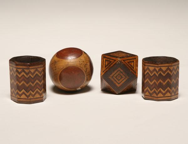 Appraisal: Four Folk Art carved wooden inlaid forms geometric sphere with