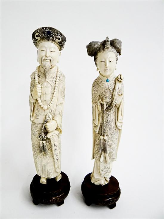 Appraisal: PAIR OF CARVED IVORY FIGURES China early th century Emperor