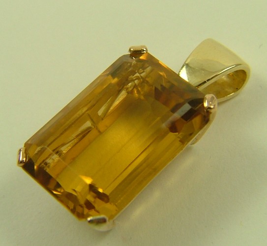 Appraisal: CITRINE AND FOURTEEN KARAT GOLD PENDANT set with an emerald-cut