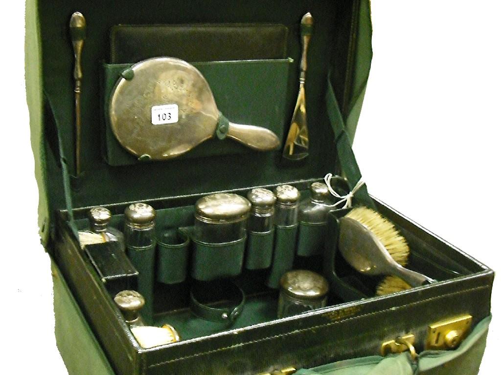 Appraisal: Large lady's leather vanity case containing silver topped scent bottles