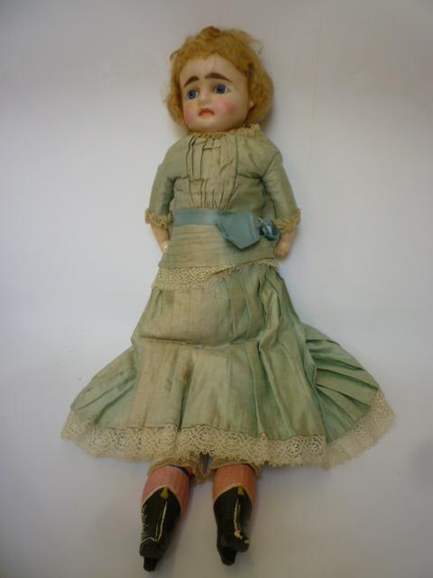 Appraisal: A wax over composition shoulder head girl doll with inset