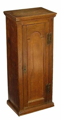 Appraisal: An oak narrow cupboard the arch panelled door enclosing two