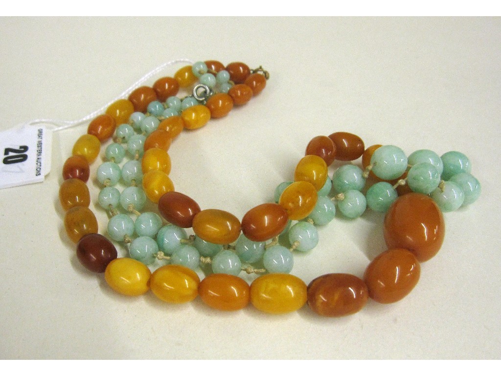 Appraisal: String of yellow amber beads cm and a string of