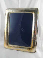 Appraisal: A large silver faced strut back photo frame with hammered