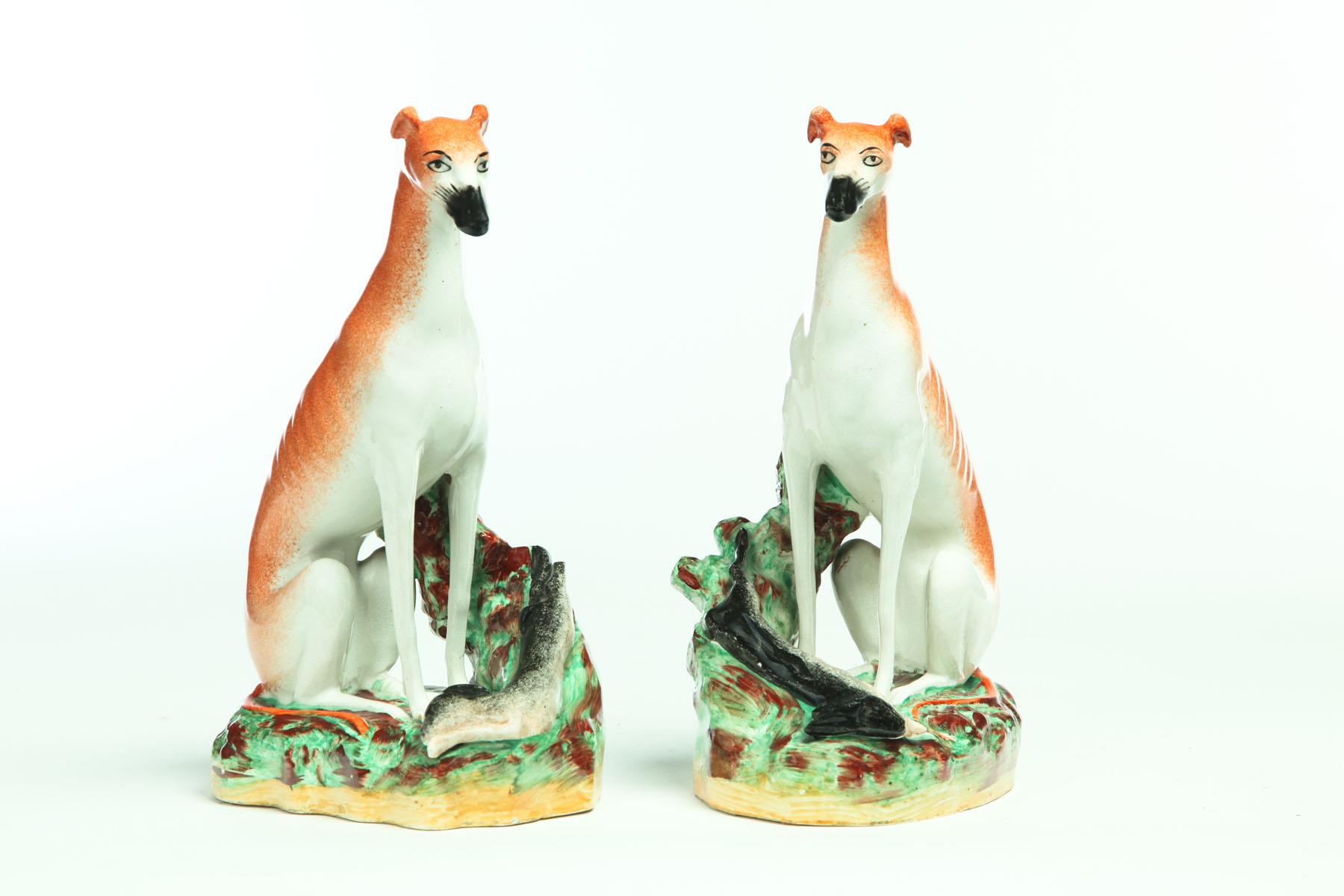 Appraisal: PAIR OF STAFFORDSHIRE WHIPPETS England nd half- th century Seated