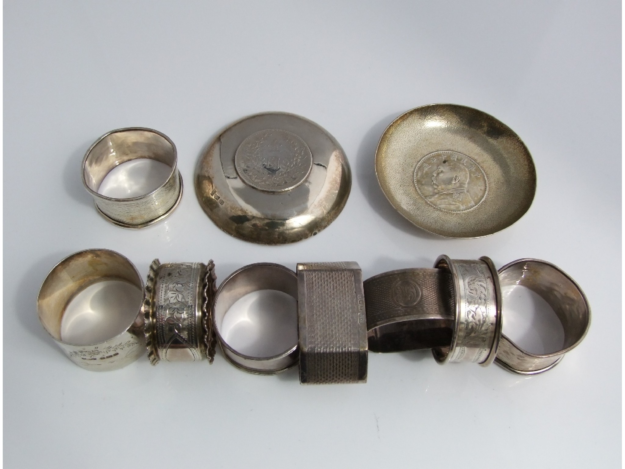 Appraisal: Two Chinese hammered silver dishes each enclosing a Yuan Ski