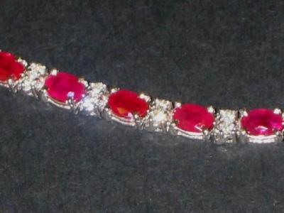 Appraisal: A RUBY AND DIAMOND BRACELET comprising eighteen oval cut rubies