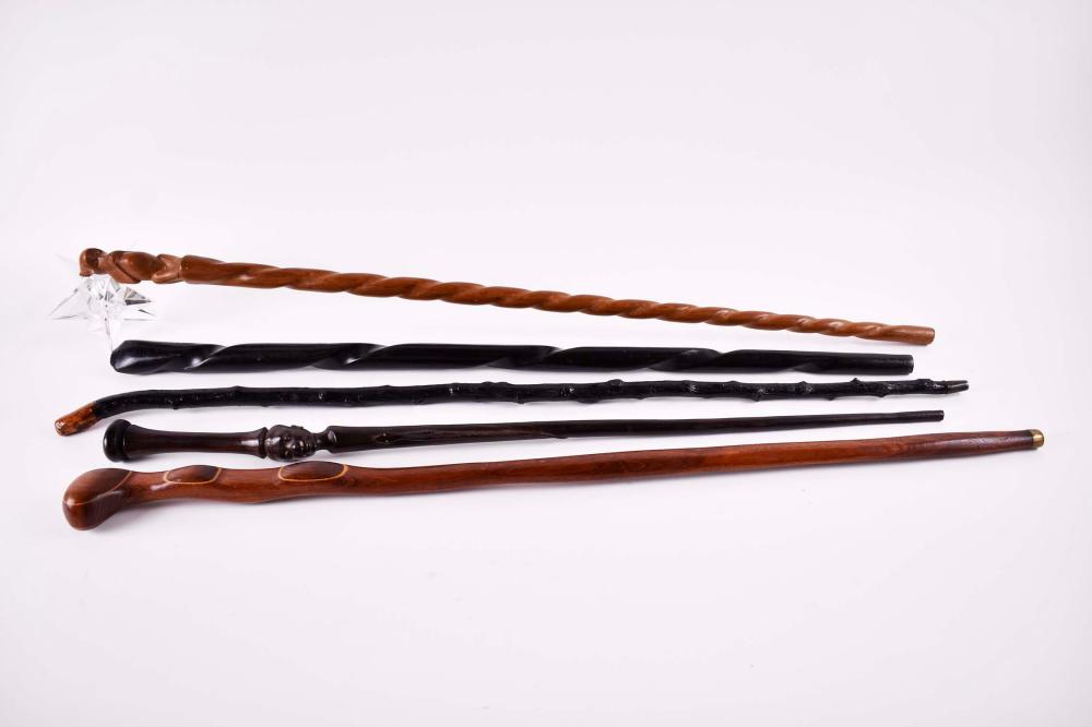 Appraisal: FOUR VARIOUS HARDWOOD WALKING STICKS AND ANOTHERComprising an African ebony