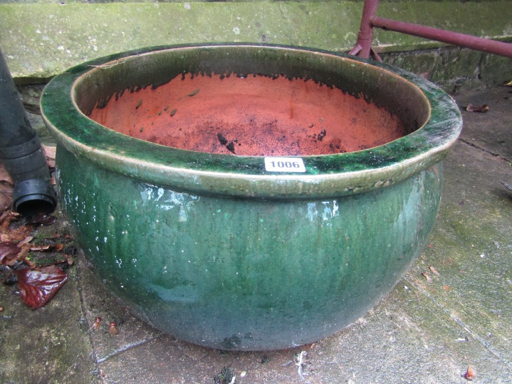 Appraisal: A contemporary green glazed terracotta planter of squat circular form