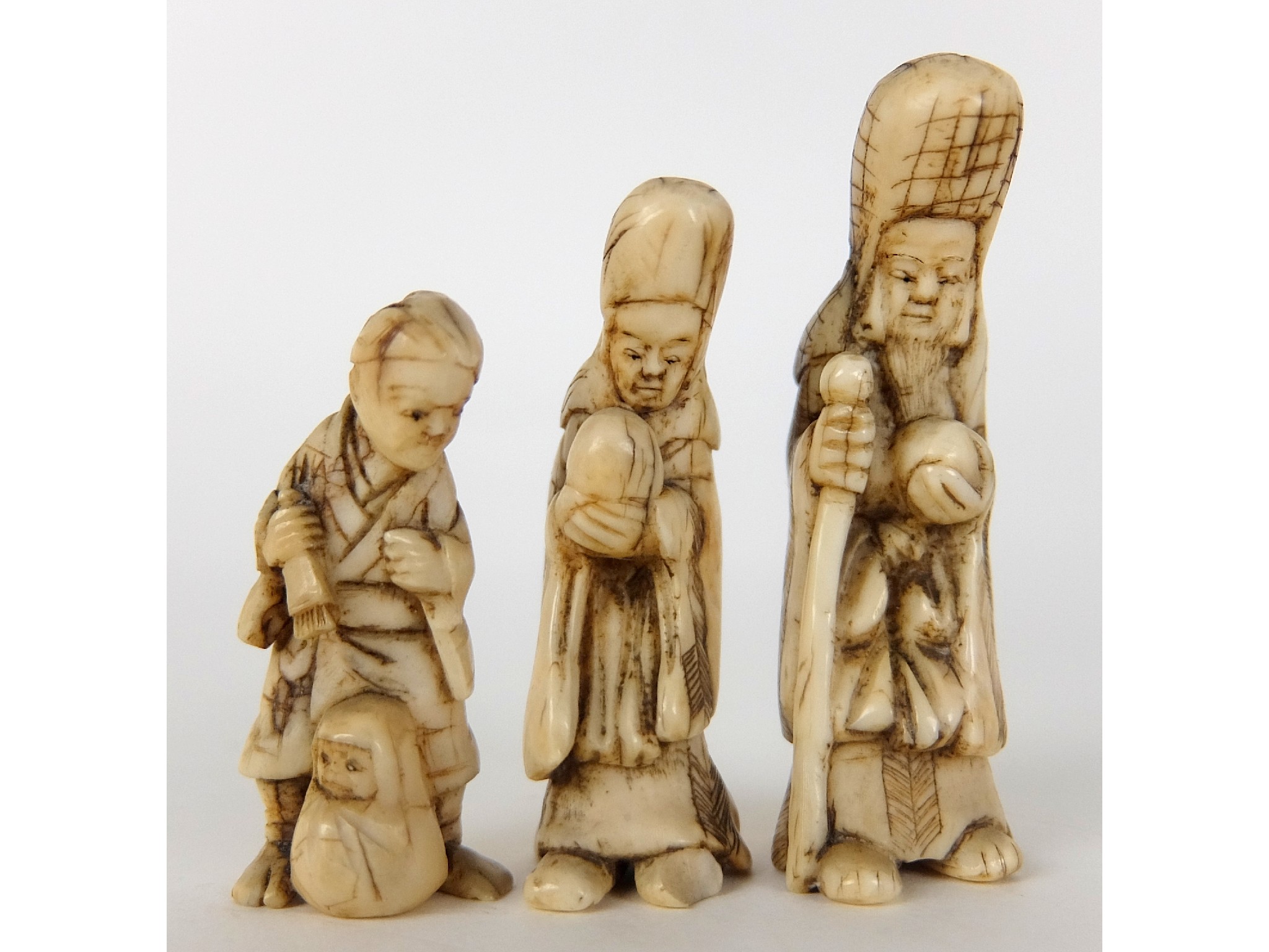 Appraisal: Two ivory figures of Shouloustanding with staff and peach and