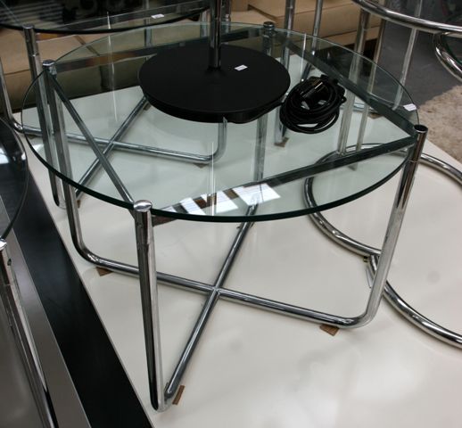 Appraisal: A chromed tubular steel and glass topped circular side table