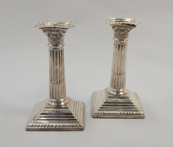 Appraisal: A pair of Edwardian silver column candlesticks cm high