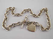 Appraisal: A white metal tests silver and marked necklace with heart