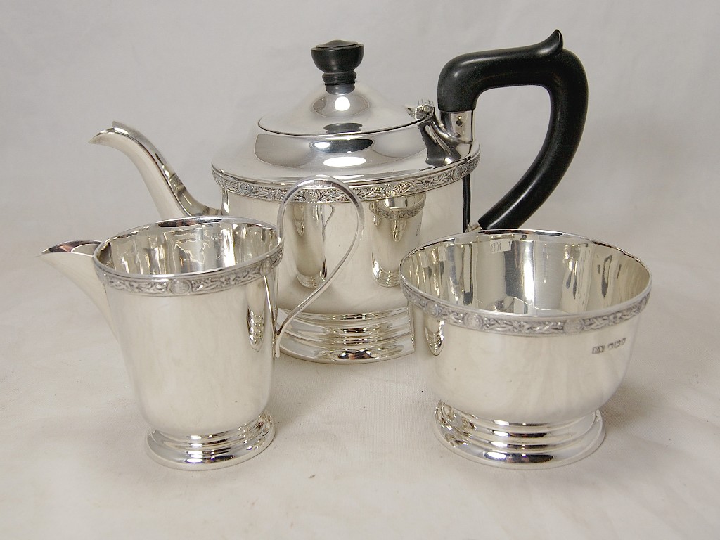 Appraisal: Three-piece circular silver tea service with Celtic border Sheffield approx