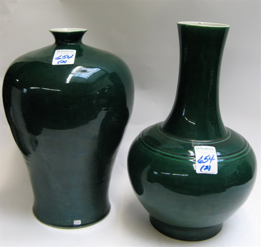 Appraisal: TWO DEEP FOREST GREEN GLAZED PORCELAIN VASES The first in